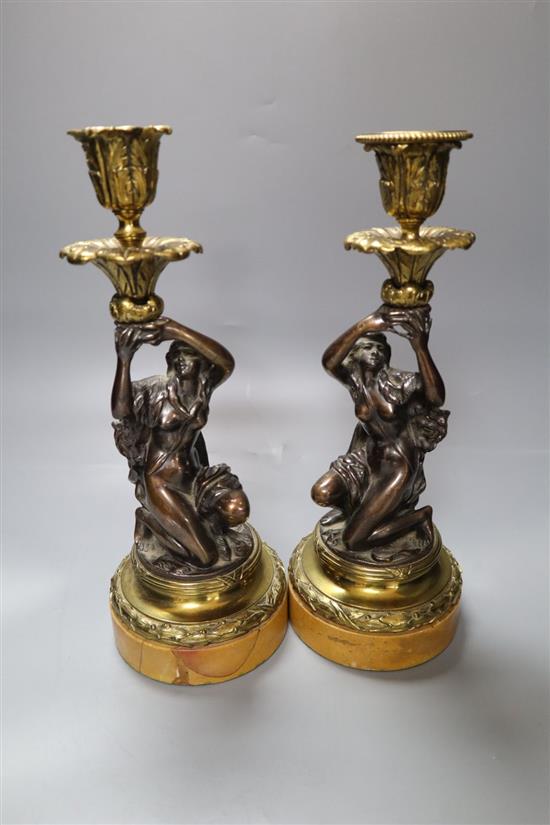 A pair of early 19th century gilt metal and bronze figural candlesticks, on marble plinths, height 29cm